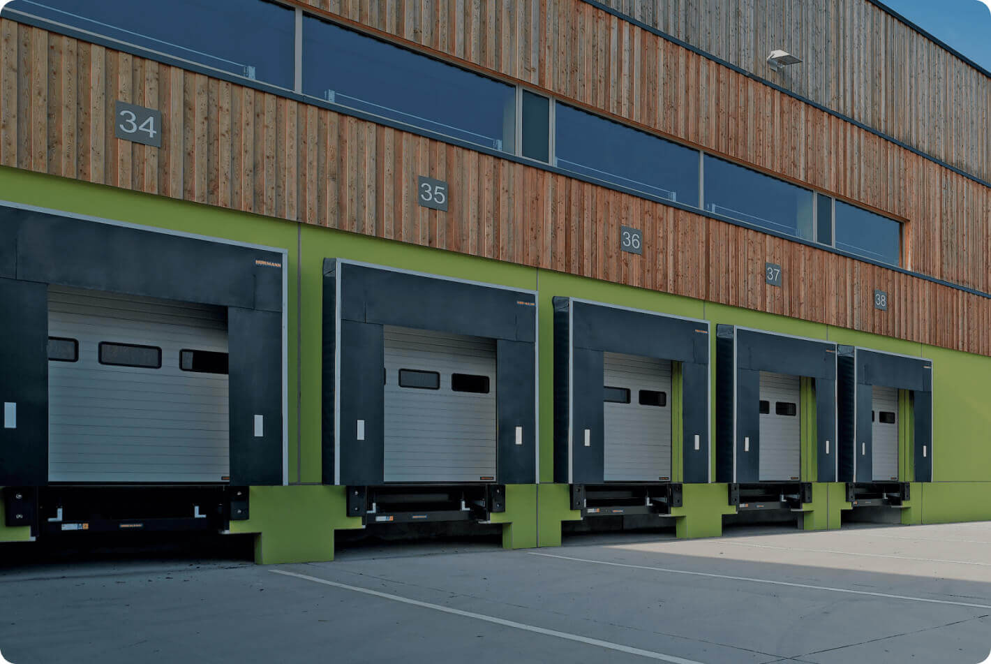 High-quality Hörmann dock leveler ensuring efficient and safe loading operations in industrial settings, and a durable Hörmann sectional door providing excellent thermal insulation and energy efficiency for commercial buildings.